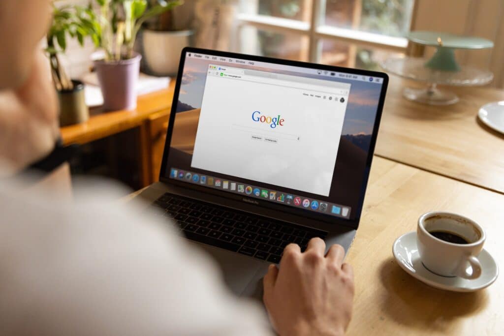 A laptop displays a Google search page. Technical SEO can help you keep up with algorithm updates on search engines like Google.