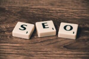 Scrabble letters spelling out 'SEO'. Technical SEO can bring more visitors to your website.